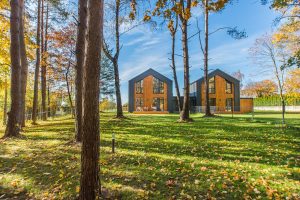 Modern architecture amidst vibrant fall landscape with colorful foliage.